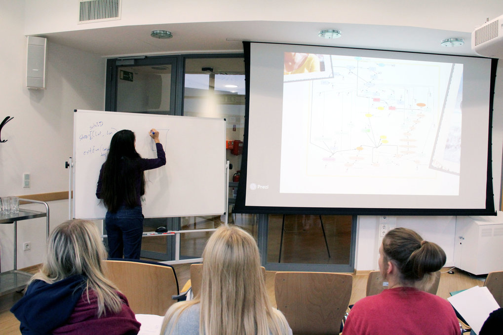 A PhD researcher is presenting her project.