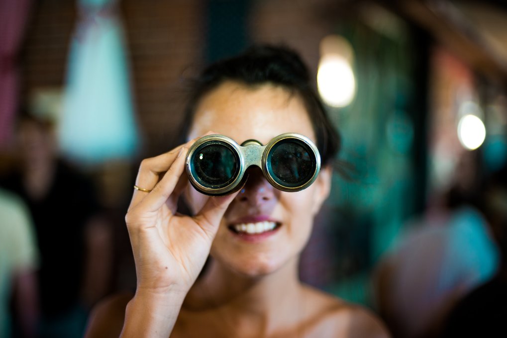 Women using grey binoculars.