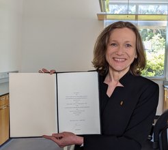 Prof. Anna Michalak with her certificate of appointment and pin.